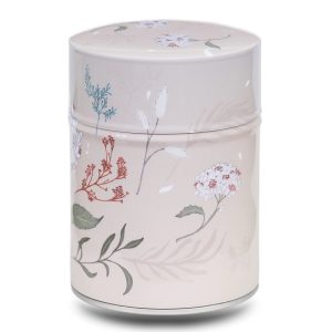 Metal tea caddy illustrated with a white flower on a beige background