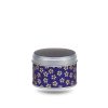 Small metal tea box covered in purple washi paper with stylized gold flowers