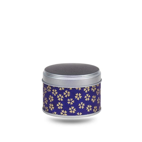 Small metal tea box covered in purple washi paper with stylized gold flowers