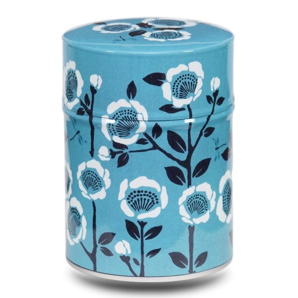 Boite à thé en métal illustrée de fleurs sur un fond bleu