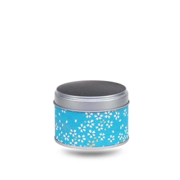 Small metal tea box covered with blue washi paper and stylized white flowers