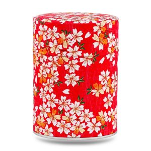 Boîte à thé artisanale Kihoku 100 g, recouverte de papier washi rouge vif aux fleurs de cerisier blanches rehaussées d’or, couvercle assorti décoré.